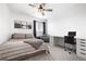 Comfortable bedroom featuring neutral tones, a ceiling fan, and a dedicated desk space at 4739 Gray Wolf Ln, Castle Rock, CO 80104