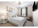 Comfortable bedroom with a king-size bed, neutral tones, and natural light from the window at 4739 Gray Wolf Ln, Castle Rock, CO 80104