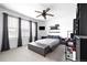 Cozy bedroom with a ceiling fan, gray drapes, and decor shelves at 4739 Gray Wolf Ln, Castle Rock, CO 80104