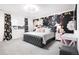 Beautiful bedroom featuring a unique accent wall, a comfortable bed, and soft lighting at 4739 Gray Wolf Ln, Castle Rock, CO 80104
