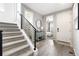 Bright entryway with stairs, modern decor, and a glimpse into the primary bedroom at 4739 Gray Wolf Ln, Castle Rock, CO 80104