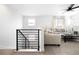 Upstairs living area with comfortable seating and a staircase with modern railings at 4739 Gray Wolf Ln, Castle Rock, CO 80104