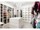 Spacious walk-in closet with custom shelving, storage island, and a decorative chandelier at 4739 Gray Wolf Ln, Castle Rock, CO 80104