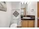 Well-lit bathroom with new fixtures, modern toilet, and stylish vanity at 13516 Thorncreek Cir, Thornton, CO 80241