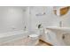 Bathroom featuring a white toilet, pedestal sink, and a tiled shower over a tub at 13516 Thorncreek Cir, Thornton, CO 80241