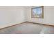 Empty bedroom offering natural light from window, neutral colors, and plush carpet at 13516 Thorncreek Cir, Thornton, CO 80241