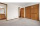 Bedroom with multiple doors, wood trim and carpeted floor at 13516 Thorncreek Cir, Thornton, CO 80241