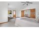 Bright bedroom featuring an additional sitting area, neutral decor, and wood trim at 13516 Thorncreek Cir, Thornton, CO 80241