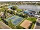 Aerial view of community featuring tennis courts, beach volleyball, swimming pool, playground and lake at 13516 Thorncreek Cir, Thornton, CO 80241