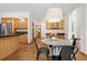 Inviting dining area with hardwood floors, access to kitchen and featuring a stylish pendant light at 13516 Thorncreek Cir, Thornton, CO 80241