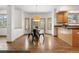 Dining area featuring hardwood floors, natural light, and neutral walls at 13516 Thorncreek Cir, Thornton, CO 80241