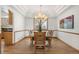 Formal dining room featuring a decorative ceiling, hardwood floors, and a modern chandelier at 13516 Thorncreek Cir, Thornton, CO 80241