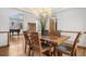 Spacious dining room adjacent to the living area, featuring hardwood floors and large windows at 13516 Thorncreek Cir, Thornton, CO 80241