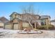 Two-story home with brick and siding exterior, a three-car garage, and an American flag on display at 13516 Thorncreek Cir, Thornton, CO 80241