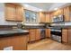 Kitchen with stainless steel appliances, ample counter space, and warm wooden cabinetry at 13516 Thorncreek Cir, Thornton, CO 80241