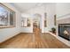 Bright living room with fireplace, hardwood floors, and neutral decor at 13516 Thorncreek Cir, Thornton, CO 80241