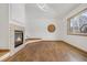 Spacious living room featuring hardwood floors, fireplace, and neutral paint at 13516 Thorncreek Cir, Thornton, CO 80241