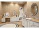 Opulent bathroom with double vanities, decorative mirrors, and intricate tile work at 8833 Portico Ln, Longmont, CO 80503