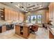 Well-lit craft room with custom cabinets, a large central island, and multiple workstations, ideal for creative projects at 8833 Portico Ln, Longmont, CO 80503