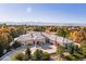 Expansive home with large driveway and meticulously landscaped front yard, against a backdrop of mountains and colorful foliage at 8833 Portico Ln, Longmont, CO 80503