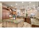 Gourmet kitchen featuring a large center island, custom cabinetry, and pendant lighting at 8833 Portico Ln, Longmont, CO 80503