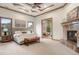 Spacious bedroom featuring a fireplace, coffered ceiling, and windows offering views of the landscape at 8833 Portico Ln, Longmont, CO 80503