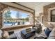 Inviting outdoor living space with stone accents, comfortable seating, and views of the pool at 8833 Portico Ln, Longmont, CO 80503