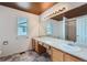 Bathroom features vanity with sink, large mirror with lighting, tile floors and a shower and bath at 22162 E Alamo Ln, Centennial, CO 80015