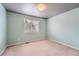 Bedroom with window, neutral carpet and light paint at 22162 E Alamo Ln, Centennial, CO 80015