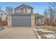 Two-story home with a blue exterior, brick accents, a two-car garage, and a well-maintained front yard at 22162 E Alamo Ln, Centennial, CO 80015