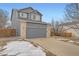 Two-story home with a blue exterior, brick accents, a two-car garage, and a well-maintained front yard at 22162 E Alamo Ln, Centennial, CO 80015