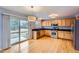 Kitchen with stainless steel appliances, wood cabinets, and sliding glass doors to the backyard at 22162 E Alamo Ln, Centennial, CO 80015