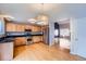 Kitchen with stainless steel appliances, wood cabinets, and hardwood floors at 22162 E Alamo Ln, Centennial, CO 80015