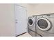 Laundry room with washer, dryer and white door at 22162 E Alamo Ln, Centennial, CO 80015