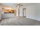 Open living room leading to the kitchen and hallway at 22162 E Alamo Ln, Centennial, CO 80015