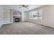 Living room featuring fireplace with shelving on either side and large window at 22162 E Alamo Ln, Centennial, CO 80015