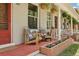 Quaint front porch with comfortable seating and beautiful flower planters, creating a welcoming entrance at 4165 Winona Ct, Denver, CO 80212