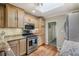Bright kitchen featuring stainless steel appliances, stone counters, and a skylight at 4165 Winona Ct, Denver, CO 80212