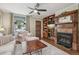 Cozy living room features a fireplace, custom built-ins and natural light at 4165 Winona Ct, Denver, CO 80212