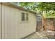 Exterior of backyard storage shed with double doors and a window at 4165 Winona Ct, Denver, CO 80212