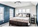 Bright bedroom with a king-size bed, neutral decor, and two windows at 14721 E Poundstone Dr, Aurora, CO 80015