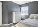 Bright bedroom with gray walls, white dresser, and a comfortable bed at 14721 E Poundstone Dr, Aurora, CO 80015