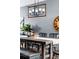 Farmhouse-style dining room with a long wooden table and black metal chairs at 14721 E Poundstone Dr, Aurora, CO 80015