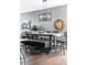 Farmhouse-style dining room with a long wooden table and black metal chairs at 14721 E Poundstone Dr, Aurora, CO 80015