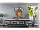 Farmhouse-style dining room with a long wooden table and black metal chairs at 14721 E Poundstone Dr, Aurora, CO 80015