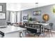 Open concept dining room with a rustic table and bench seating at 14721 E Poundstone Dr, Aurora, CO 80015