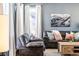 Living room with hardwood floors, neutral color palette, and comfy leather furniture at 14721 E Poundstone Dr, Aurora, CO 80015