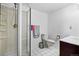 Bathroom showcasing a tiled shower, toilet, and a vanity with cabinet storage space at 5197 S Perry St, Littleton, CO 80123