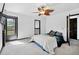 Comfortable bedroom with a ceiling fan, exterior access, and neutral carpet at 5197 S Perry St, Littleton, CO 80123