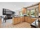 Bright kitchen featuring custom cabinets, granite countertops, and an open layout at 5197 S Perry St, Littleton, CO 80123